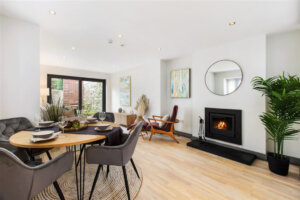 furnished living room with wooden floors and fireplace